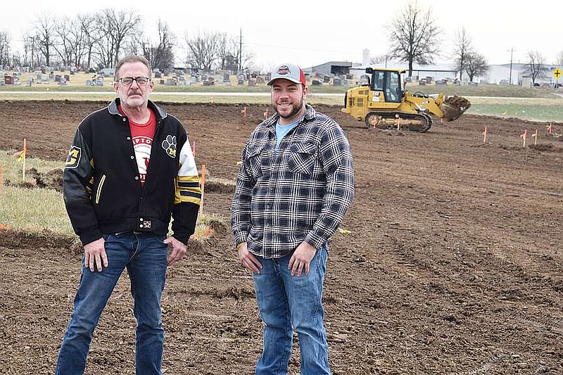 Democrat photo/Garrett Fuller — Moniteau County Presiding Commissioner Joe Lutz, left, and Northern Commissioner Clint Hoellering pose Friday (Jan. 5, 2024,) at the site of Moniteau County Sheriff's Office's future home on the southeastern corner of Windmill Ridge Drive and East Buchanan Street as a member of Darrell Wilbers Excavating, of Jefferson City, prepares the ground for construction of the new facility.
