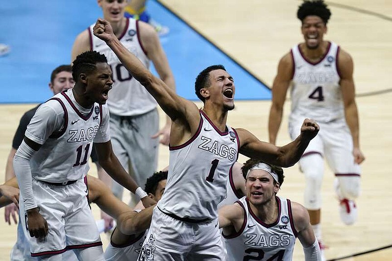 FILE - Gonzaga guard Jalen Suggs (1) celebrates making the game-winning basket against UCLA during overtime in a men's Final Four NCAA college basketball tournament semifinal game, Saturday, April 3, 2021, at Lucas Oil Stadium in Indianapolis. Gonzaga won 93-90. (AP Photo/Michael Conroy, File)