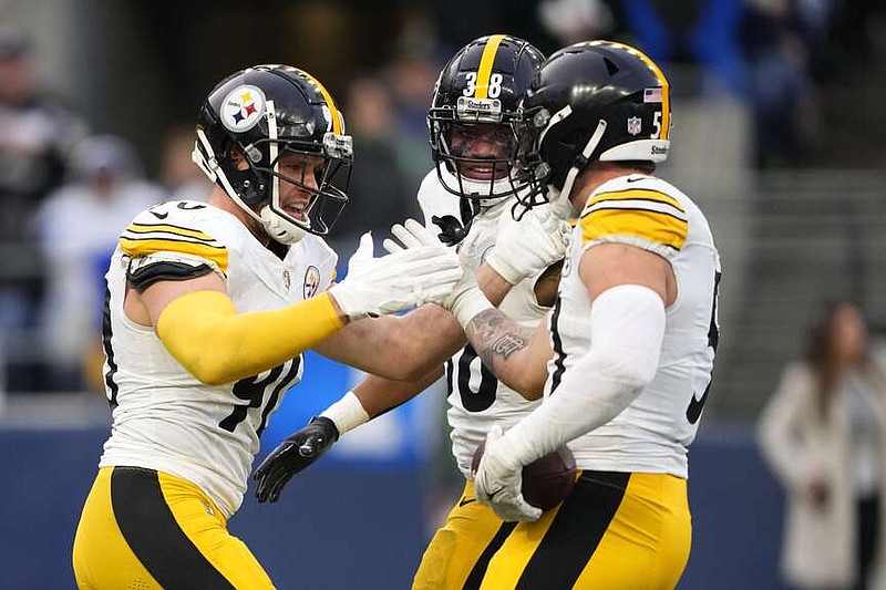 Pittsburgh Steelers linebacker Nick Herbig, right, is congratulated by T.J. Watt (90) and Mykal Walker (38) after Herbig forced a fumble and recovered the ball against the Seattle Seahawks in the second half of an NFL football game Sunday, Dec. 31, 2023, in Seattle. (AP Photo/Lindsey Wasson)