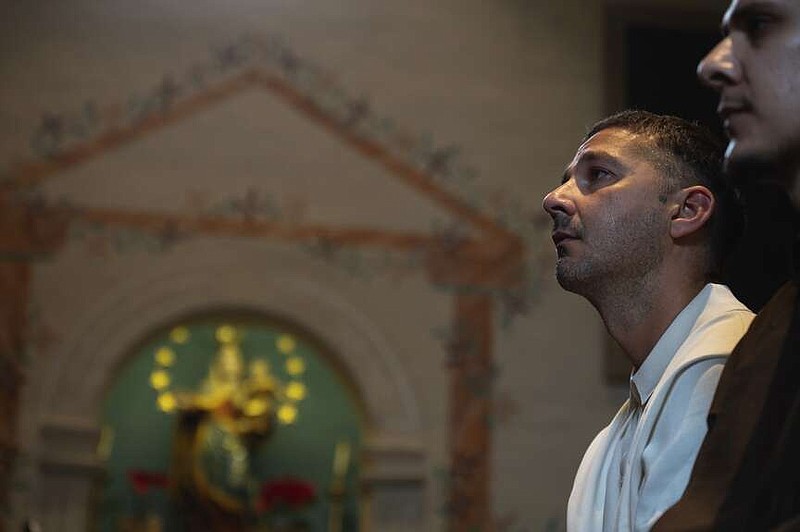 In this photo provided by Word on Fire Catholic Ministries, actor Shia LaBeouf participates in his Catholic confirmation ceremony at Old Mission Santa Inés Parish in Solvang, Calif., on Sunday, Dec. 31, 2023. “The Capuchin Franciscan friars are overjoyed to welcome him into the fold and witness his deep commitment to his faith journey,” the Catholic religious order said. (Word on Fire Catholic Ministries via AP)