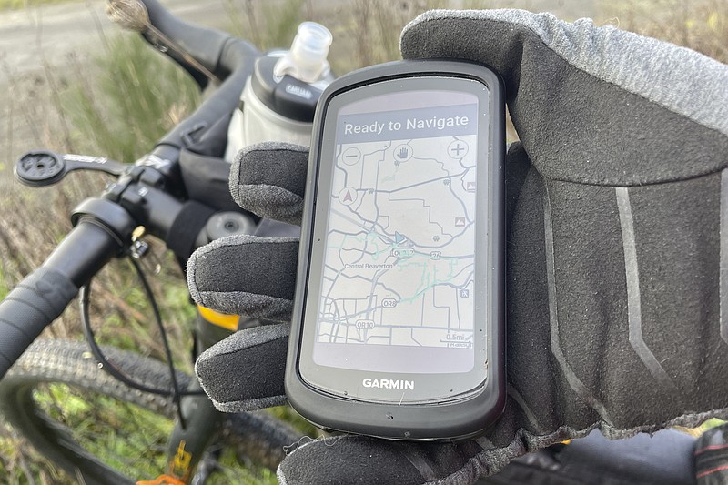 On a personal electronic GPS, Beaverton, Ore., resident Adam Pirkle shows the 14 miles he rode on his bicycle in his neighborhood and around southwest Portland, Ore., Sunday, Jan. 7, 2024, looking for the fuselage of a Boeing 737 Max 9 that detached shortly after the takeoff of an Alaska Airlines flight on Friday, Jan. 5. The National Transportation Safety Board estimated the fuselage may have fallen in the area. (AP Photo/Claire Rush)