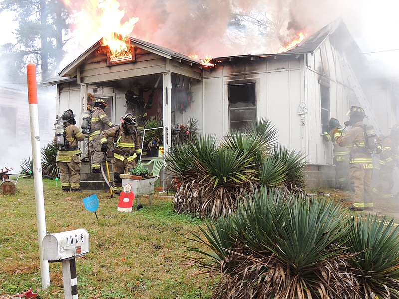 Photo by Jennifer Kimble

Camen Firefighters fight a house fire on Highland Park Drive.