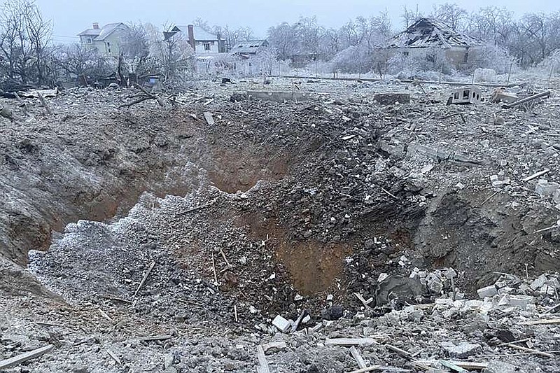 FILE - In this photo provided by the Ukrainian Emergency Service, a crater of an explosion is seen next to the private building destroyed after a Russian missile attack in Novomoskovsk, near Kryvyi Rih, Ukraine, Monday, Jan. 8, 2024. Russia's recent escalation of missile and drone attacks is stretching Ukraine's air defense resources, a Ukrainian air force official said Tuesday, Jan. 9, 2024, leaving the country vulnerable in the 22-month war unless it can secure further weapons supplies. (Ukrainian Emergency Service via AP, File)