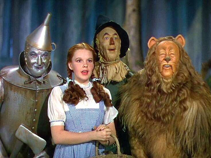 Four friends — (from left) Jack Haley as the Tin Man, Judy Garland as Dorothy Gale, Ray Bolger as the Scarecrow and Bert Lahr as the Cowardly Lion — travel to, from and back to the Emerald City, seeking the fabulous title Wizard while battling the Wicked Witch of the West in “The Wizard of Oz.”
(Special to the Democrat-Gazette/© Turner Entertainment Co.)