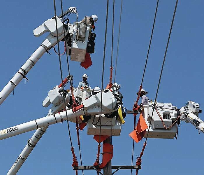 Utility workers with Entergy Arkansas work on power lines at University Ave. and F Street in Little Rock on Tuesday, July 25, 2023. (Arkansas Democrat-Gazette/Colin Murphey)