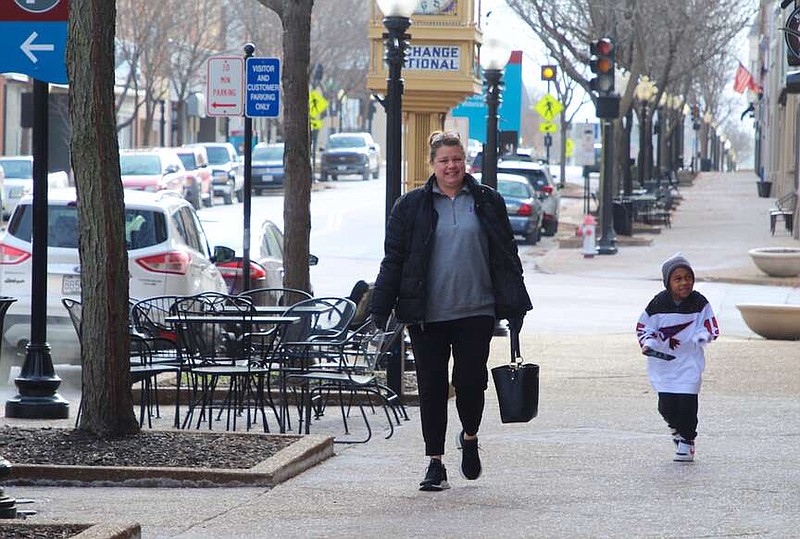 Alexa Pfeiffer/News Tribune photo: 
Jennifer and Mo O'Neill walk down High Street on Saturday morning, conquering the wind chill in the 9 degree weather.