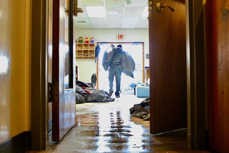 Alexa Pfeiffer/News Tribune photo:
Kevin Baker of SERVPRO of Jefferson City removes bags of damaged items from the Boys & Girls Club's Sadowski Center on Wednesday, Jan. 17, 2024, following a water leak.