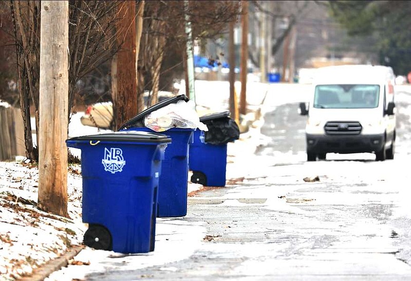 Uncollected garbage fills garbage cans Thursday Jan. 18, 2024 along Maple Street in North Little Rock. Winter weather has delayed trash pickup in Little Rock, North Little Rock and in the county. (Arkansas Democrat-Gazette/Staton Breidenthal).