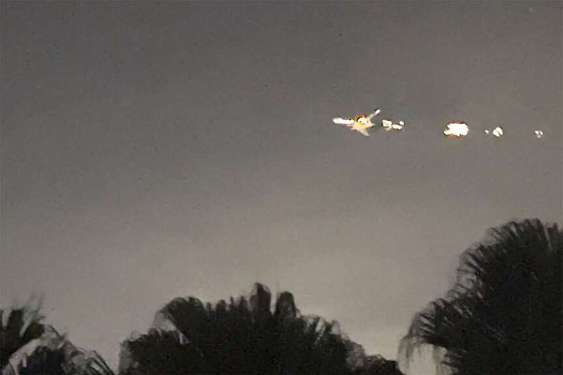This image taken from video provided by Melanie Adaros shows   sparks shooting from a cargo plane before making an emergency landing at Miami International Airport on Thursday, Jan. 18, 2024 in Miami.  The aircraft landed safely Thursday night “after experiencing an engine malfunction soon after departure," a spokesperson for Atlas Air said in a statement Friday. “The crew followed all standard procedures and safely returned to MIA."  (Melanie Adaros via AP)