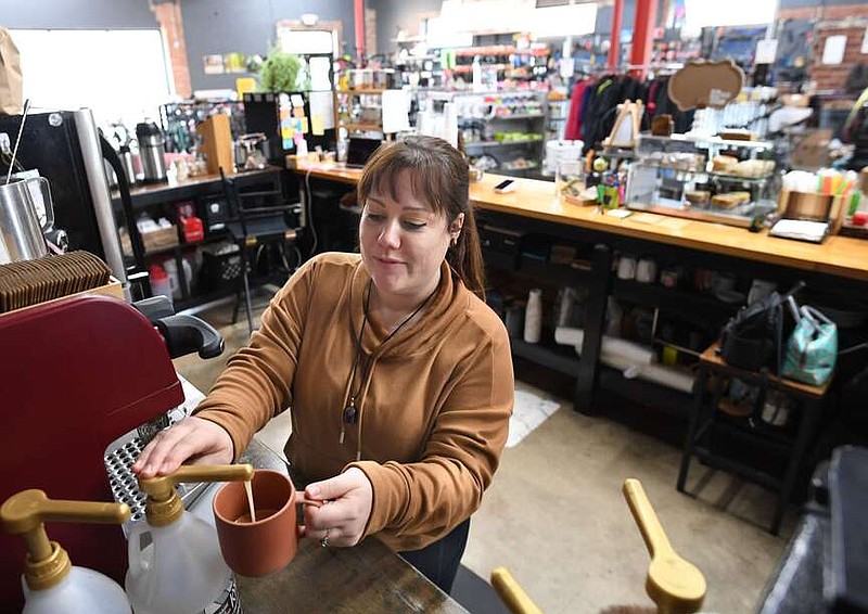 Katie Schneider, owner of Trailside Coffee Company,  Friday, Jan. 19, 2024, makes a coffee drink inside her business in downtown Springdale. A planned sewer project needed for the new Hilton Hotel will require Emma Avenue at Spring Street to be dug up for a couple of days and the area to be a work zone for 30-45 days, something that concerns Schneider whose business is among several in the area that have been affected by work downtown. Visit nwaonline.com/photo for today's photo gallery.
(NWA Democrat-Gazette/Andy Shupe)