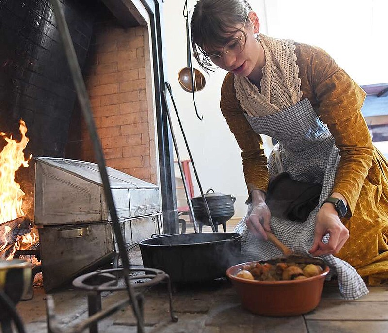 Morgan Weithman, public programs coordinator, prepares lunch for the Arkansas History Museum staff and volunteers Saturday during the Living Craft Saturday: Turning up the Heat event at the Arkansas History Museum.
(Arkansas Democrat-Gazette/Staci Vandagriff)