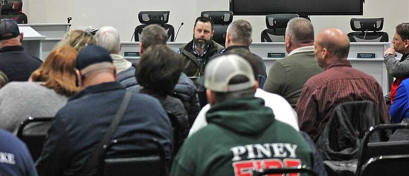 Visit Hot Springs Marketing Director Bill Solleder, right, listens as Garland County Department of Emergency Management Director Bo Robertson addresses the crowd at a planning meeting for the April 8 eclipse. (The Sentinel-Record/James Leigh)