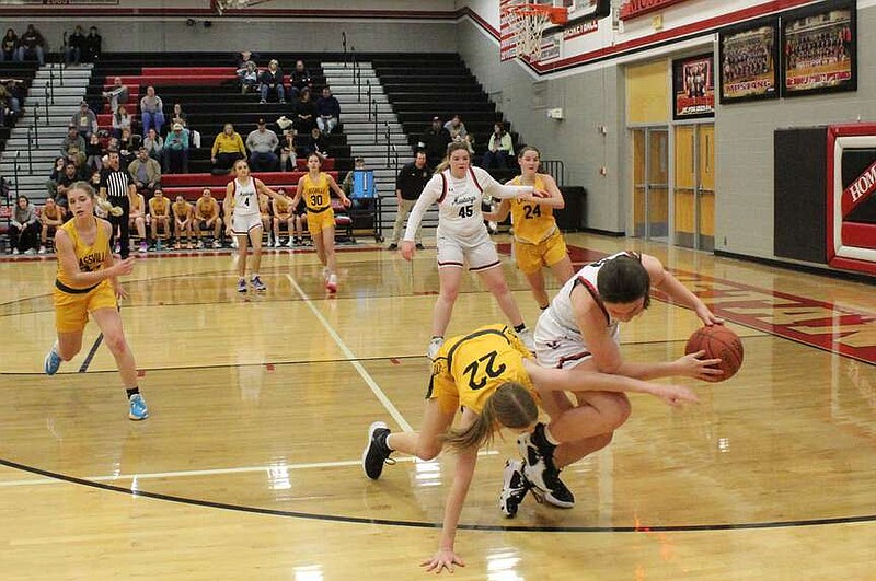 Daniel Bereznicki/McDonald County Press Anna Clarkson (white) dived for the ball and caught it before it could go out of bounds.