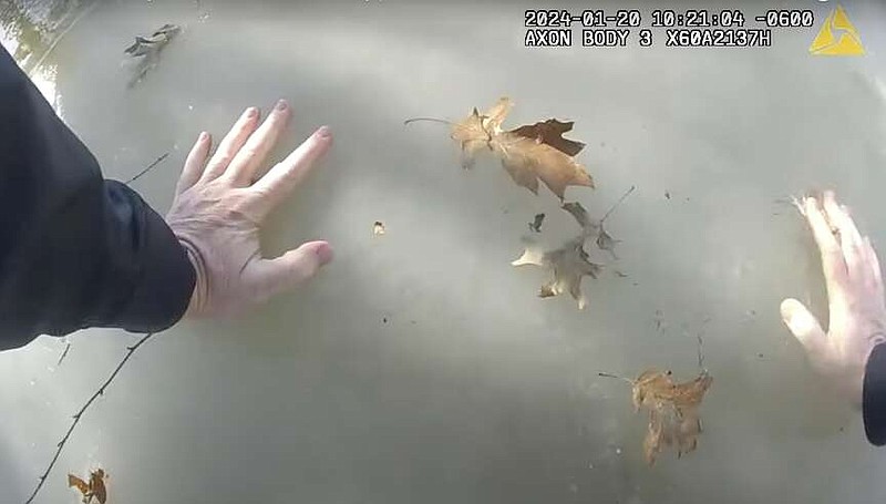 Jonesboro Police Officer Troy Ellison is shown navigating across an icy pond in an attempt to rescue a child in this still of video taken from Ellison's bodycam. (Courtesy of the Jonesboro Police Department)