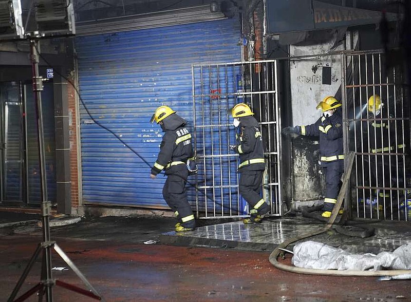 Firefighters work at the site of a building fire in Xinyu City, east China's Jiangxi Province, Wednesday, Jan. 24, 2024. Chinese state media say at least 39 people died and nine others were injured after a fire broke out in southeastern Jiangxi province. State broadcaster CCTV reported that local authorities said that the fire broke out Wednesday afternoon. The building houses an internet cafe in the basement and tutoring centers on upper floors. Local government officials were deployed to the scene in addition to first responders. (Zhou Mi, Xinhua via AP)