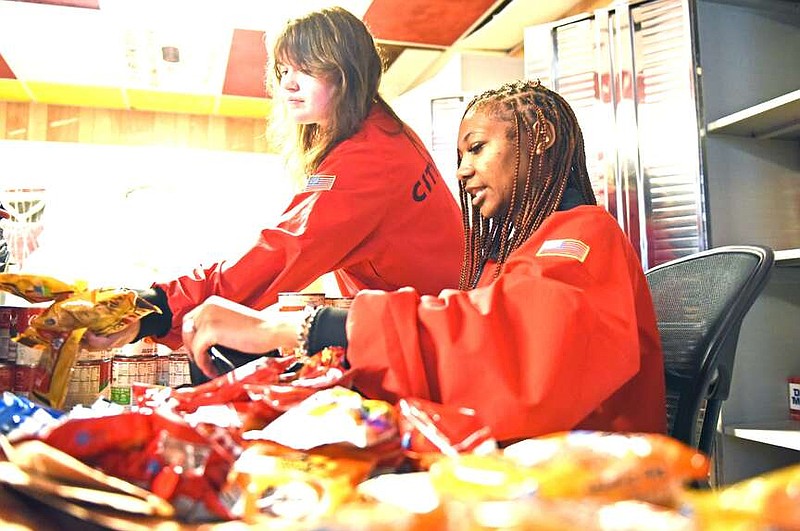 Renn Ryles (front) and Kat Holitik, both City Year AmeriCorps members, sort food Saturday during the MLK Day of Service at Mabelvale Middle School in Little Rock.
(Arkansas Democrat-Gazette/Staci Vandagriff)