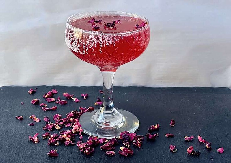 Gimme Some Sugar Cocktail prepared with a plain sugar rim and garnished with dried rose petals (Arkansas Democrat-Gazette/Kelly Brant)