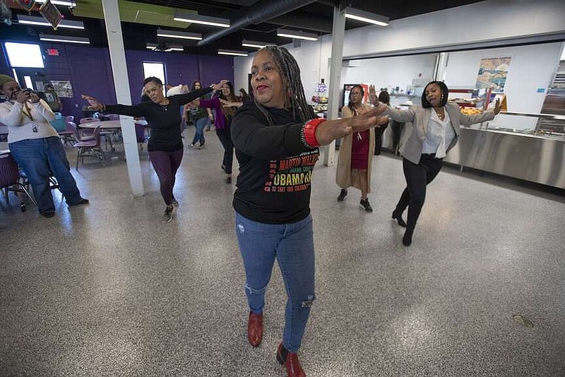 Pamela Coleman along with other guests dance during the city-wide kickoff of Black History Month Monday Jan. 29, 2024 at Fayetteville ALLPS School of Innovation.  Several Black History Month Legacy honorees were recognized, including former Razorback head basketball coach Nolan Richardson. The school has activities planned all February to celebrate Black History Month. Visit nwaonline.com/photo for today's photo gallery. (NWA Democrat-Gazette/J.T. Wampler)