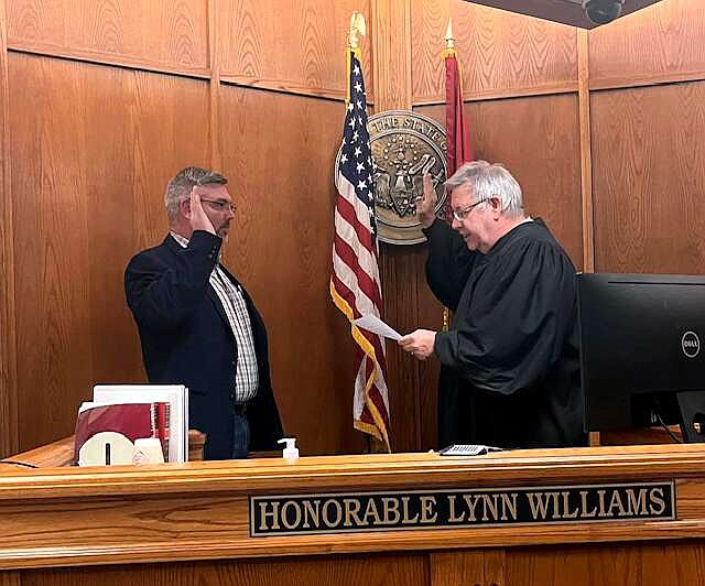 Division 3 Circuit Judge Lynn Williams, right, swears in Jayson Neighbors as county coroner Tuesday morning at the county courthouse. (Submitted photo)
