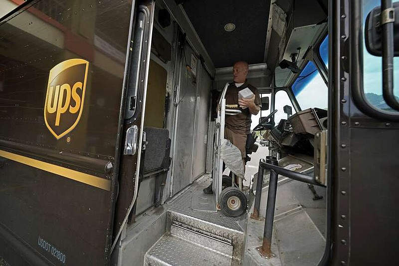 UPS driver Joe Speeler makes a delivery at the Leanon Shops in Mount Lebanon, Pa., on Tuesday, Sept. 21, 2021. (AP Photo/Gene J. Puskar)