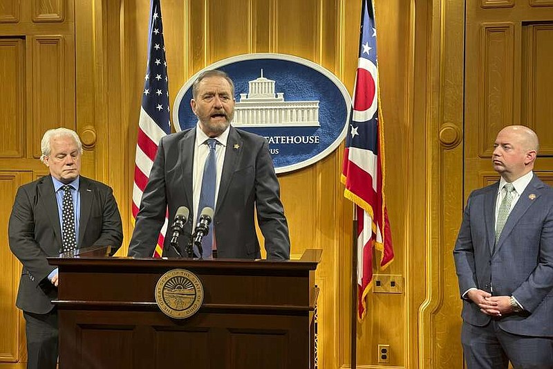 Republican Ohio Attorney General Dave Yost speaks at a news conference Tuesday, Jan. 30, 2024, at the Ohio Statehouse in Columbus, Ohio, where he expressed his support for legislation that would allow the state to begin using nitrogen gas to carry out the death penalty. Yost is flanked by the bill's sponsors, state Reps. Phil Plummer, left, and Brian Stewart. (AP Photo/Julie Carr Smyth)