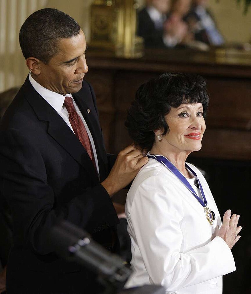 FILE - President Barack Obama places a 2009 Presidential Medal of Freedom around the neck of Chita Rivera, Aug. 12, 2009, during a ceremony in the East Room of the White House in Washington. Rivera, the dynamic dancer, singer and actress who garnered 10 Tony nominations, winning twice, in a long Broadway career that forged a path for Latina artists, died Tuesday. She was 91. (AP Photo/Alex Brandon, File)