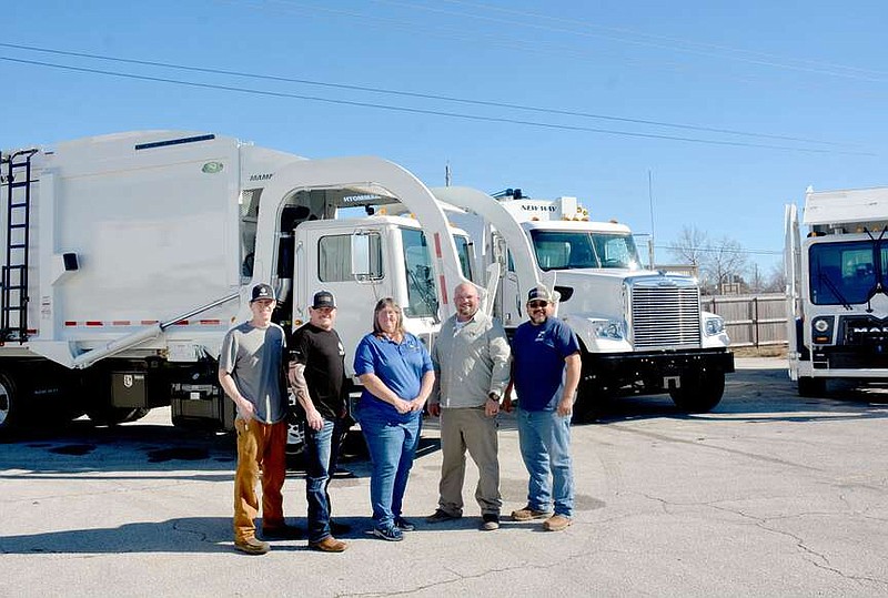 Marc Hayot/Herald-Leader Chase Sprouse (left) of Arkansas Municipal Equipment is shown with father Ronnie Sprouse, Maintenance Superintendent Araminta Cripps, Director of Public Service Jason Davis and Solid Waste Superintendent Kevin Whaler in front of new sanitation vehicle leased by the city on Jan. 31 at the maintenance shop.