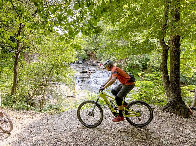 Submitted photo 
A cyclist takes the Tunnel Vision Trail by Tanyard Falls. Cyclists of all abilities are invited to join the Bella Vista 2024 Strava Challenge, which will offer a different challenge every month.
