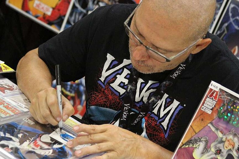 Comic book artist Sam de la Rosa draws the Spider-Man character Venom at his booth at Spa-Con at the Hot Springs Convention Center in September 2019. De la Rosa has worked for both DC and Marvel comics. (The Sentinel-Record/File photo)