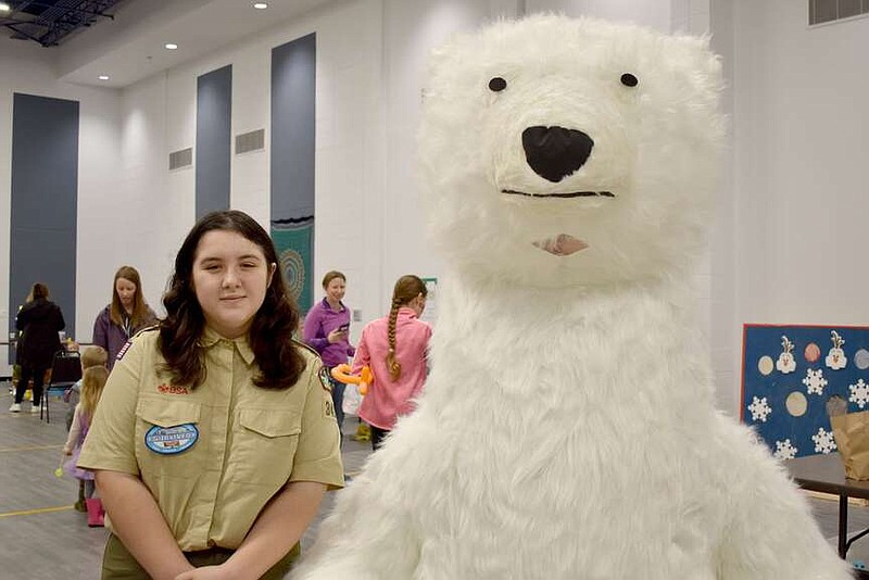Rachel Dickerson/The Weekly Vista
Alina Villa of the girls' Boy Scout Troop 3401G is pictured with a "polar bear" at Winterfest at the Bella Vista Recreation Center on Feb. 3.