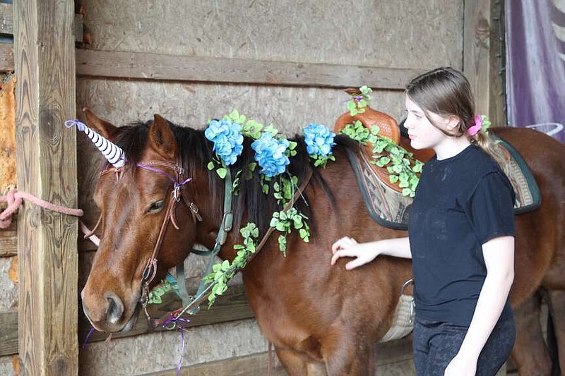 Alexa Pfeiffer/News Tribune photo: 
Lily Stokes prepares final decorations on her unicorn, Sasha, Saturday, Feb. 3, 2024, for the Sparkling Hooves and Enchanted Woods ride at Iron Wing Ranch in Callaway County.