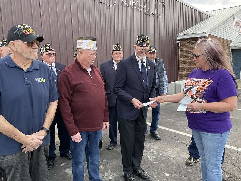 California Democrat/Kaden Quinn photo: 
Robbie D's Bar and Grill co-owner Kim Rimel presents a check for $172.33 to Andrew Suddarth, of American Legion Post 304, for his organization. From left, Marlo Vansickle, of DAV Chapter 17 and Larry Stegeman, of VFW Post 4345, wait to accept their organization's checks.