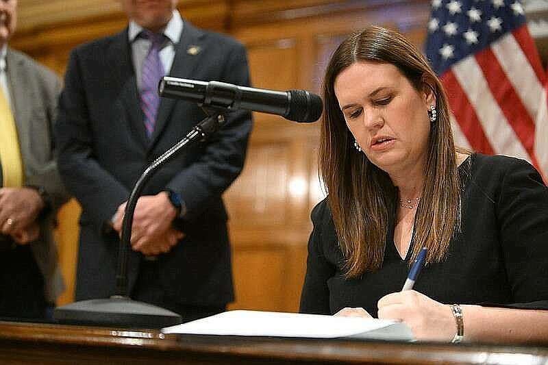 Gov. Sarah Huckabee Sanders signs a bill into law at the state Capitol in this Jan. 26, 2023 file photo. (Arkansas Democrat-Gazette/Staci Vandagriff)