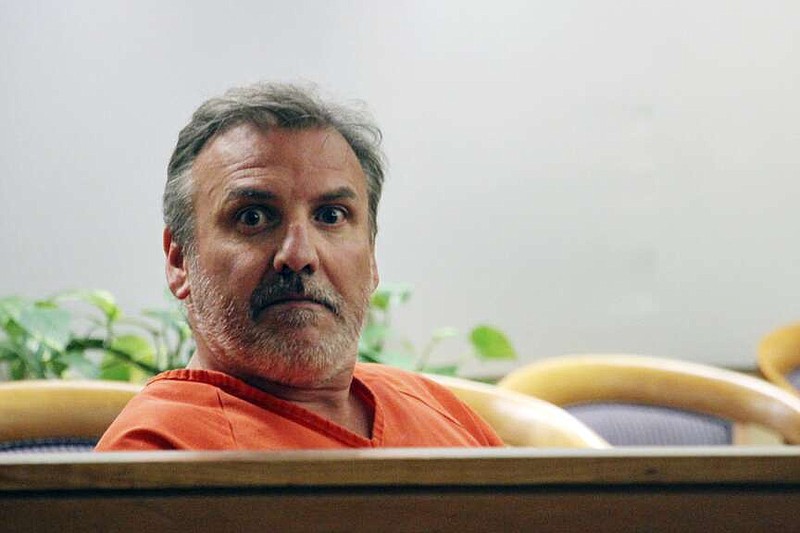 FILE - Brian Steven Smith sits in a courtroom while waiting for his arraignment to start in Anchorage, Alaska, Oct. 16, 2019. The double murder trial of Smith, a South Africa native accused of killing two Alaska Native women will begin this week, more than four years after a woman provided police with a digital memory card that authorities said contained images and video of one of the killings. (AP Photo/Mark Thiessen, File)