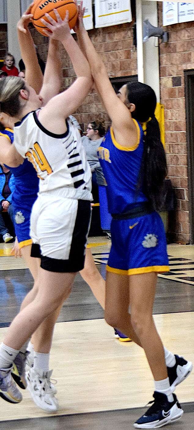 Mike Eckels/Special to the Observer
Lady Bulldog Daisy Fuentes gets a hand on the ball, preventing the Lady Yellowjackets from shooting during the Mulberry-Decatur conference contest at Yellowjacket gym in Mulberry Friday night.