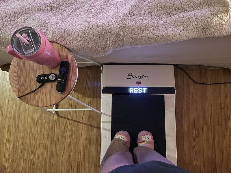 AP
Hope Zuckerbrow, founder of the cozy cardio wellness movement, shows her workout set-up, including a walking pad, smoothie and remote control for watching television.