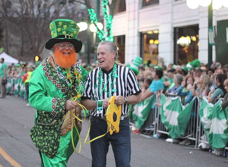 Monte Everhart, left, and Larry DeWitt get ready to measure the route at the First Ever 15th Annual World's Shortest St. Patrick's Day Parade on March 17, 2018. (The Sentinel-Record/File)