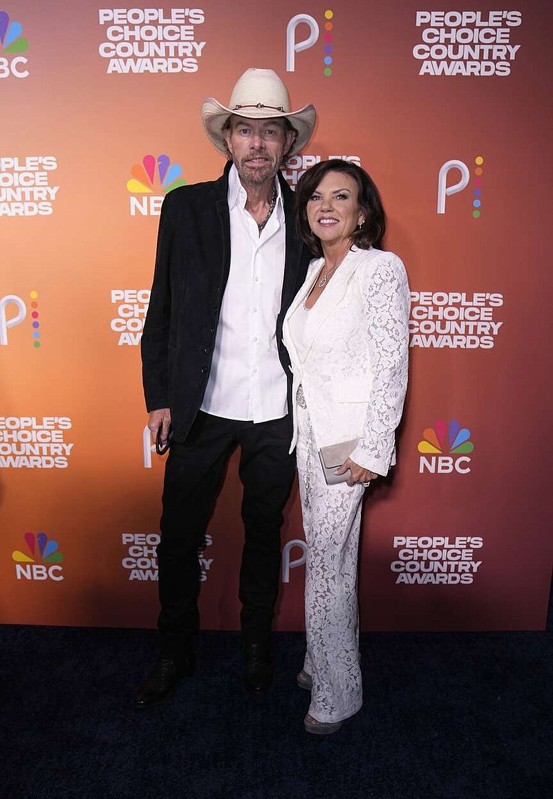 Toby Keith, left, and Tricia Lucus arrive at the People's Choice Country Awards on Thursday, Sept. 28, 2023, at The Grand Ole Opry House in Nashville, Tenn. (AP Photo/George Walker IV)