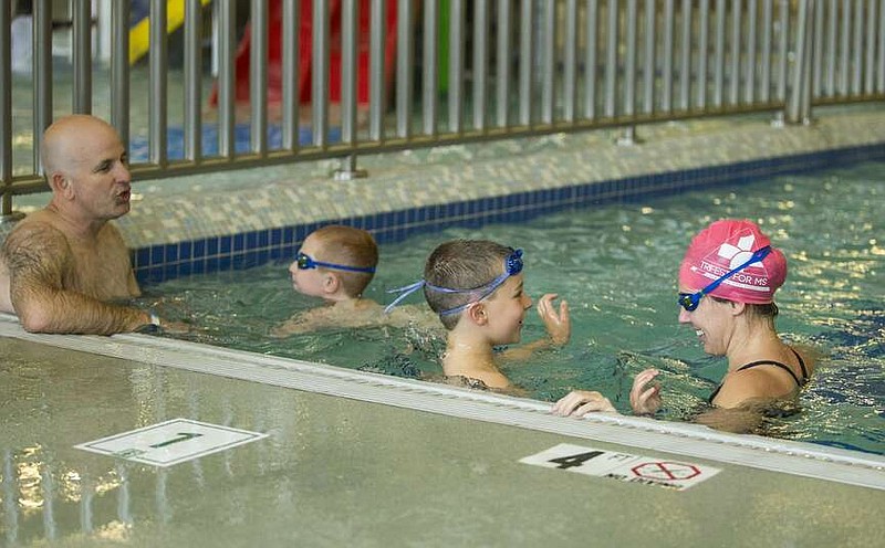 A family plays May 23, 2020, in the leisure pool at the Bentonville Community Center. Centerton Mayor Bill Edwards said Centerton is looking at the Bentonville Community Center as a model in many aspects of its plans for a community center, including the indoor swimming pool.
(File Photo/NWA Democrat-Gazette)