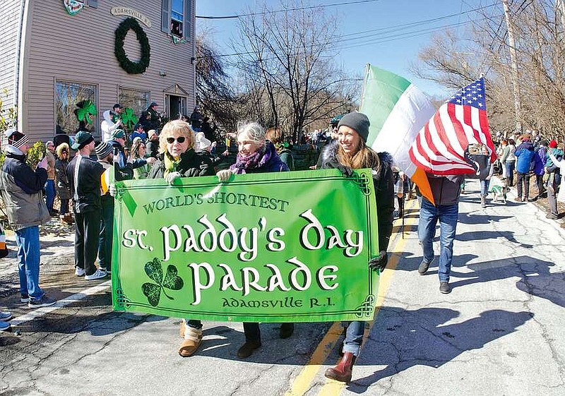 A group of women carry a sign for the World's Shortest St. Paddy's Day Parade in Adamsville, Rhode Island, on March 17, 2022. (Photo courtesy of the Sakonnet Times)