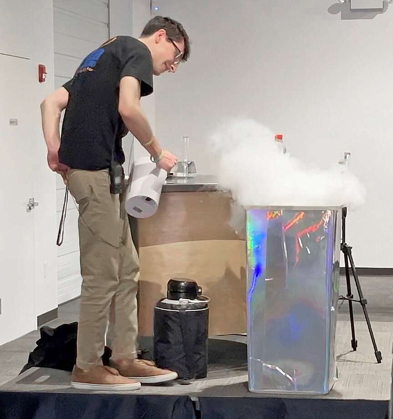 Jacob Marcus, an educator at Mid-America Science Museum, uses hot water and dry ice to create a cloud at the end of his magic show. (The Sentinel-Record/James Leigh)