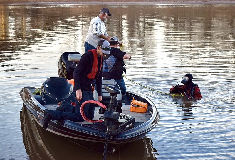 Members of the Miller County Dive Team work to retrieve several vehicles from the Red River on Thursday, Feb. 8, 2024, at Index Bridge north of Texarkana. The vehicles were located Monday as part of a search for a vehicle belonging to a woman who was reported missing from Texarkana in 1987. It was unknown late Thursday if any of the vehicles are related to any missing-person cases. (Staff photo by Stevon Gamble)