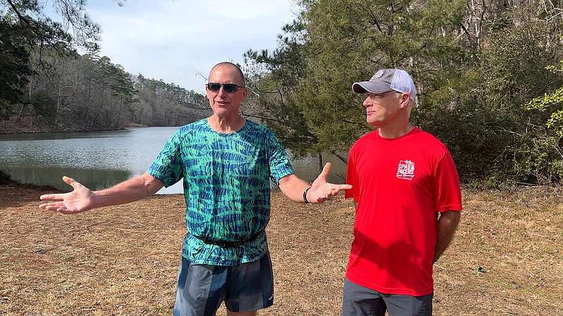 Dave Hochstedler discusses the new divisions to the Northwoods Mullet Trail Run for dogs as fellow trail runner Greg Bunn looks on. (The Sentinel-Record/James Leigh)