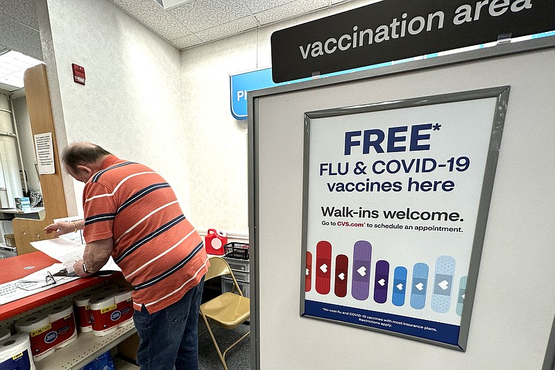 FILE - A sign for flu and covid vaccinations is displayed at a pharmacy store in Palatine, Ill., Wednesday, Sept. 13, 2023. The flu is hanging on in the U.S., intensifying in some areas of the country after weeks of apparent decline., according to data released by the U.S. Centers for Disease Control and Prevention on Friday, Feb. 9, 2024. (AP Photo/Nam Y. Huh, File)