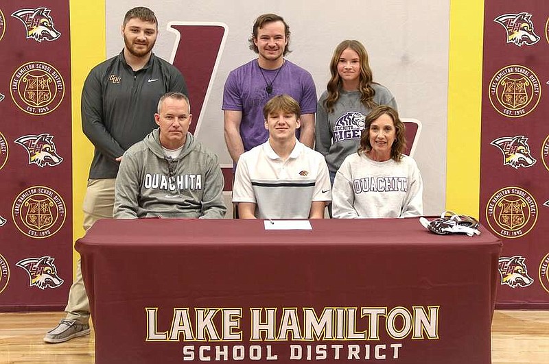 Lake Hamilton senior Hunter Baber, center, is pictured with his family and friends on Wednesday at Wolf Arena after signing to wrestle at Ouachita Baptist University this fall. (Submitted photo)