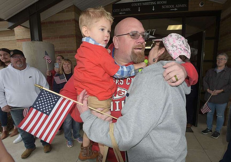 Sgt. Andrew Butterworth carries his son, Hudson, 2, while greeting well wishers at Pea Ridge City Hall on Saturday Feb. 10 2024 during a celebration honoring Butterworth and his family who will soon move into a home provided by the national Homes for Our Troops organization. Butterworth was severely injured while serving in Iraq. The home is under construction in Pea Ridge and is equipped with several adaptations to allow increased mobility for Butterworth, who lost his right leg and sustained a traumatic brain injury when twoa rocket propelled grenades hit the vehicle he was in. Go nwaonline.com/photos for today's photo gallery.
(NWA Democrat-Gazette/Flip Putthoff)