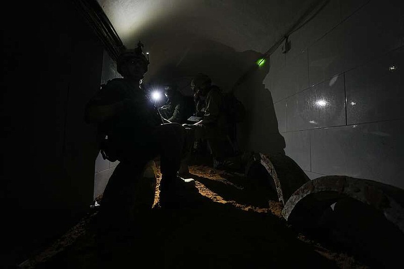 Israeli soldiers operate cameras inside a tunnel underneath UNRWA compound, where the military discovered tunnels in the main headquarters of the U.N. agency that the military says Hamas militants used to attack its forces during a ground operation in Gaza, Thursday, Feb. 8, 2024. The Israeli military says it has discovered tunnels underneath the main headquarters of the U.N. agency for Palestinian refugees in Gaza City, alleging that Hamas militants used the space as an electrical supply room. The unveiling of the tunnels marked the latest chapter in Israel's campaign against the embattled agency, which it accuses of collaborating with Hamas. (AP Photo/Ariel Schalit)