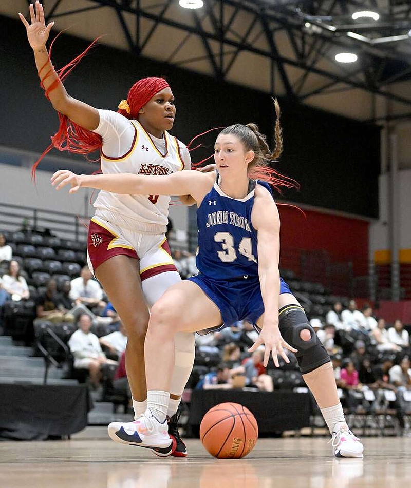 John Brown's Tarrah Stephens goes up against Loyola University's Liz Critton in the NAIA national tournament on March 7, 2023 in New Orleans, La. Stephens became JBU's all-time leading scorer on Feb. 3 when she scored her 2,035th point. 
(Courtesy of Parker Waters)
