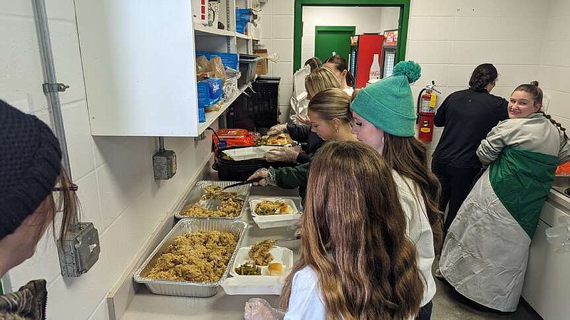 Ryan Pivoney/News Tribune photo:
The Blair Oaks girls soccer team portions jambalaya, green beans and dinner rolls into to-go containers Sunday, Feb. 11, 2024, for the team's first fundraiser of the year. The team sold the plates for $12 each.