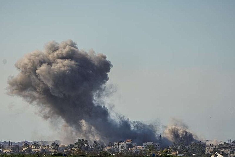 Smoke and explosion following an Israeli bombardment inside the Gaza Strip, as seen from southern Israel on Sunday. The army is battling Palestinian militants across Gaza in the war ignited by Hamas' Oct. 7 attack into Israel. (AP Photo/Ariel Schalit)
